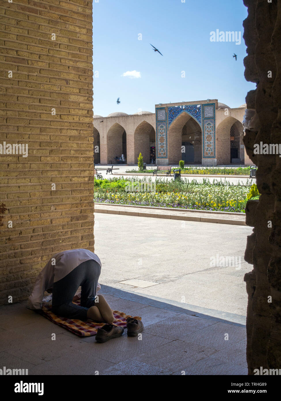 A man at mid-day prayers inside the Kerman Bazaar, known as the Ganjali Khan Complex, in Kerman, Iran. The Safavid-era building complex, built between Stock Photo