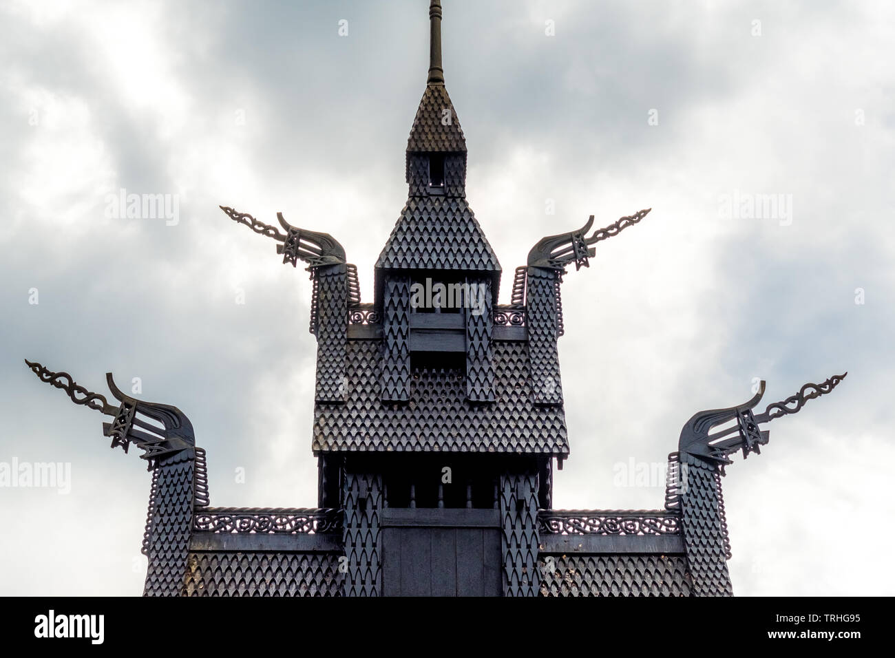 Roof construction of Fantoft Stave Church with dragon heads in the shape of a dragon's head against dramatic sky, Fantoftvegen Paradis, Hordaland, Nor Stock Photo