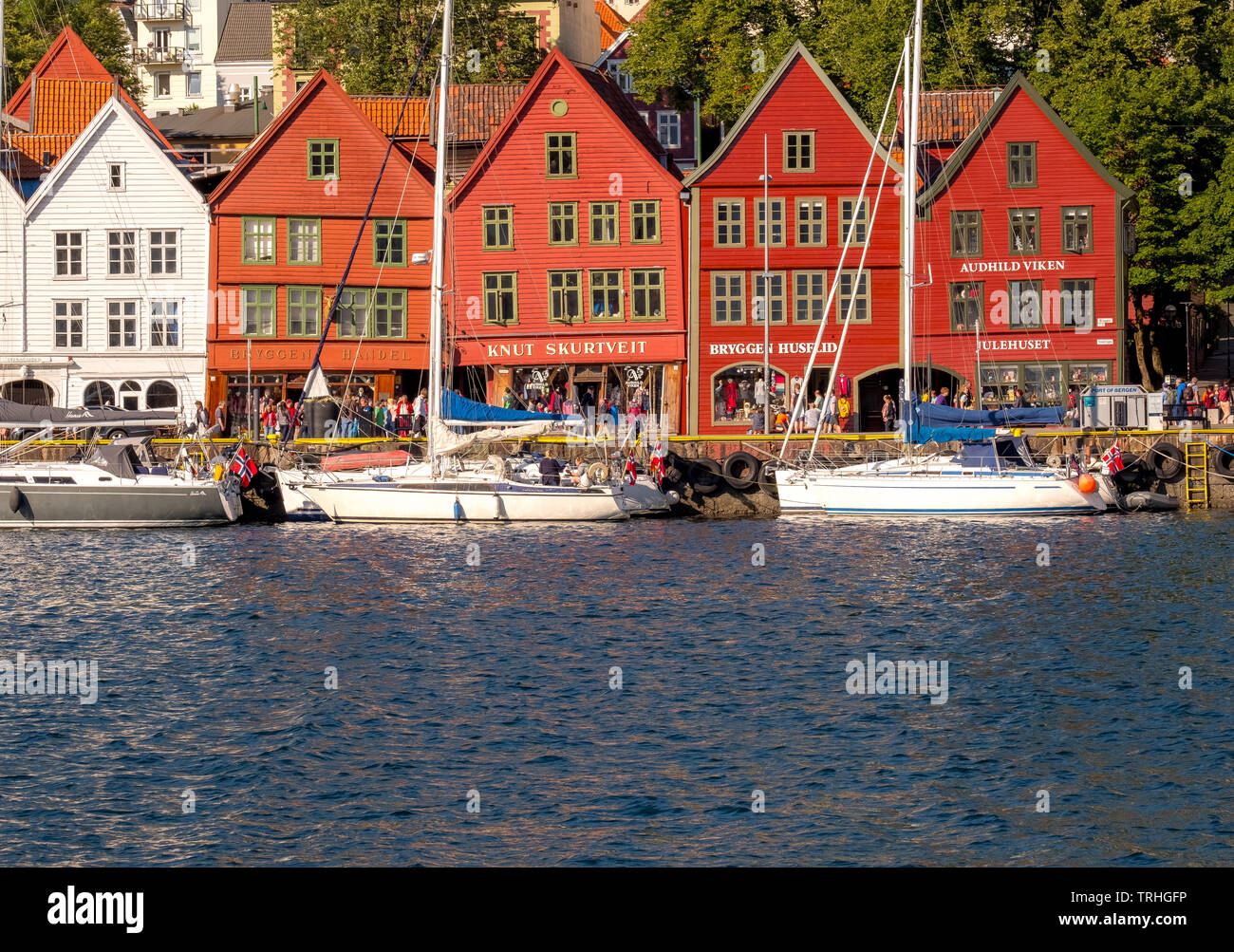 North Sea, behind a colorful wooden houses front with attached sailboats in the harbor of Bryggen, Hordaland, Norway, Scandinavia, Europe, Bergen, NOR Stock Photo