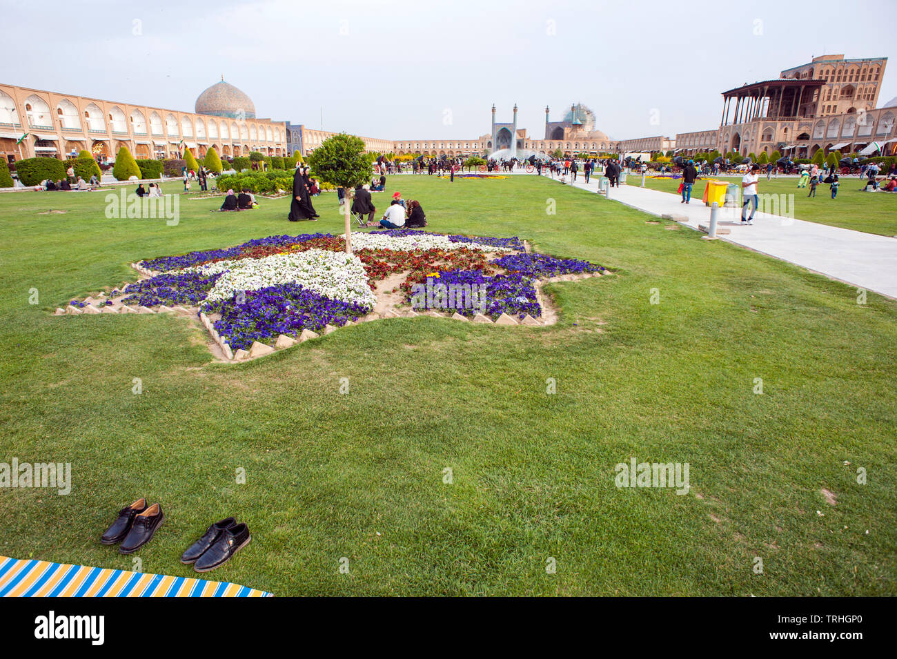 Picknickers relaxing at Maydan-e Imam Square, also known as Naqsh-e Jahan Square, in Esfahan, Iran. It is a UNESCO World Heritage Site. Stock Photo