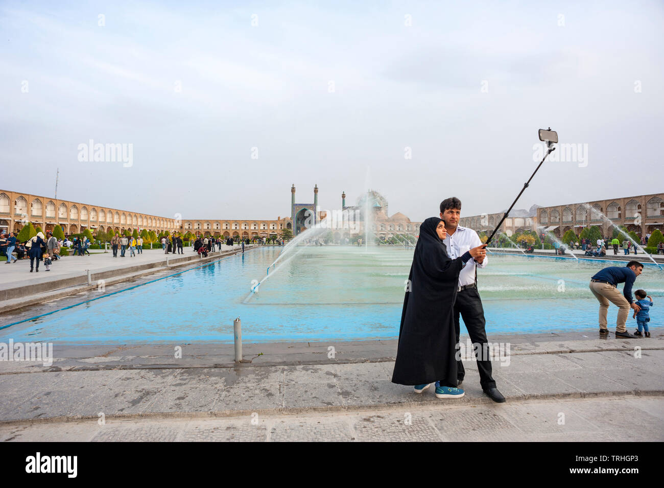 Tourists taking a selfie at Maydan-e Imam Square, also known as Naqsh-e Jahan Square, in Esfahan, Iran. It is a UNESCO World Heritage Site. Stock Photo