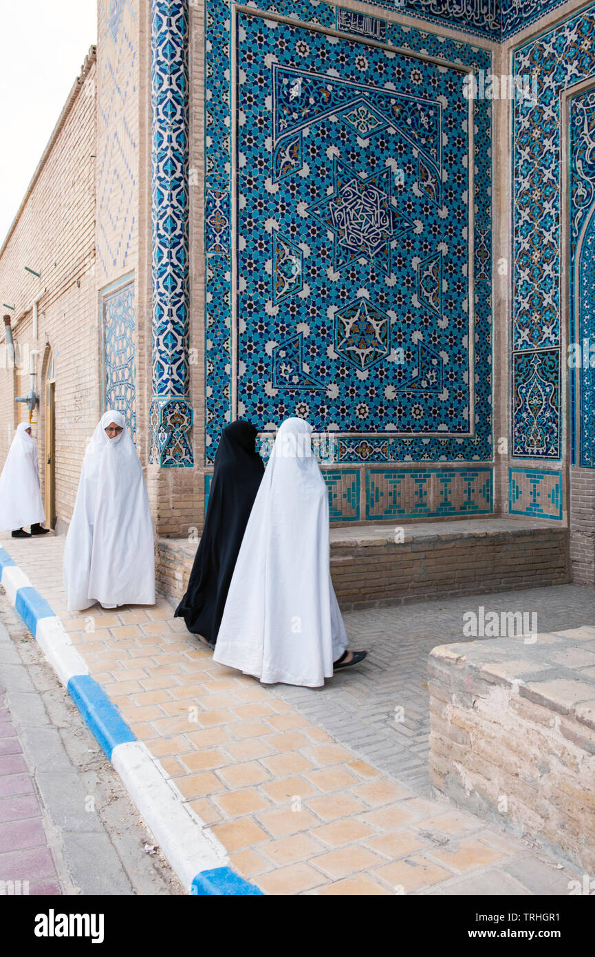 Women heading to Friday morning prayer at Jame Historical Mosque in the village of Varzaneh, Iran. Stock Photo