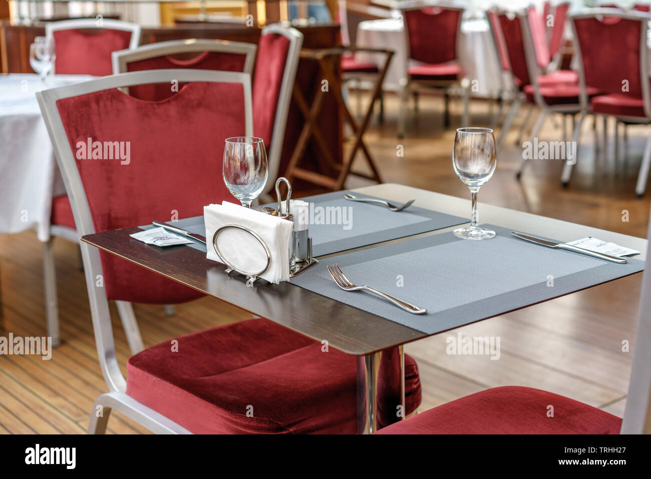 Tables, chairs and dining facilities in an empty restaurant. Stock Photo