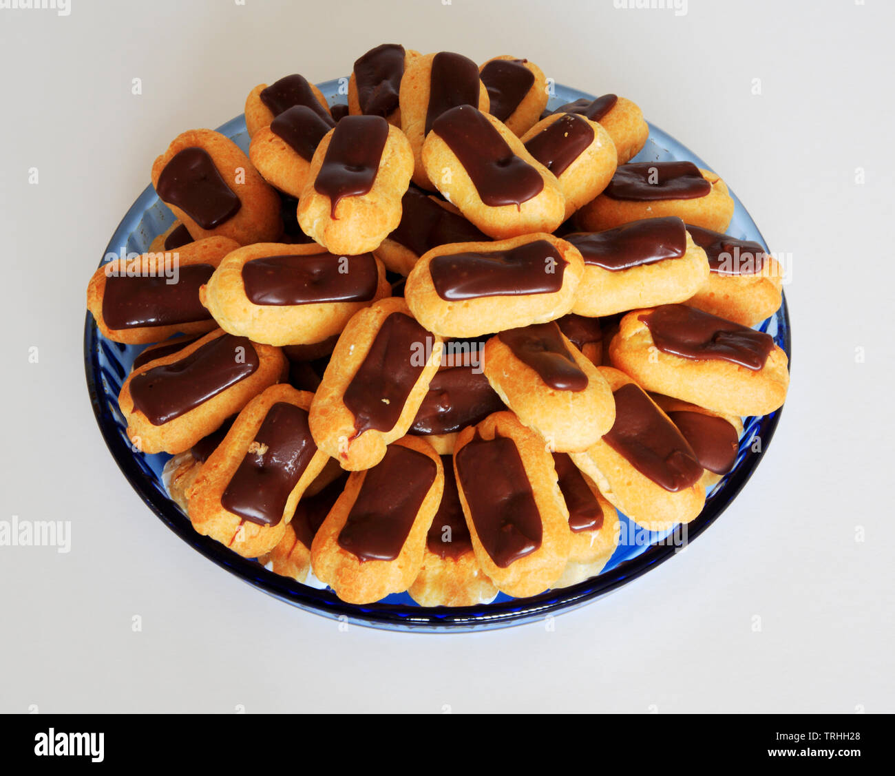A view of a dish of mini eclairs for sharing for a dessert course. Stock Photo
