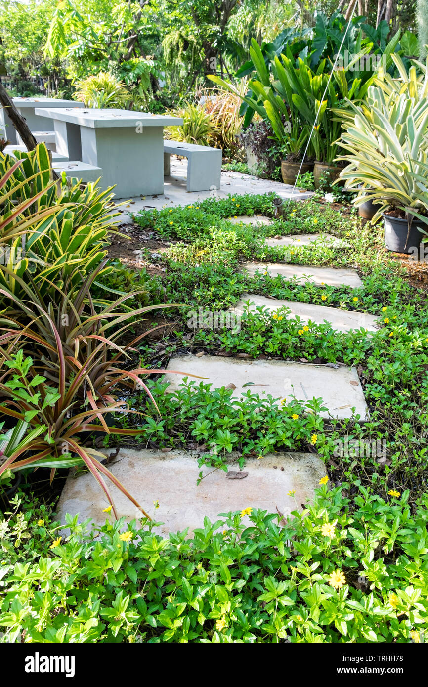 Stone curved walkway to table in garden Stock Photo
