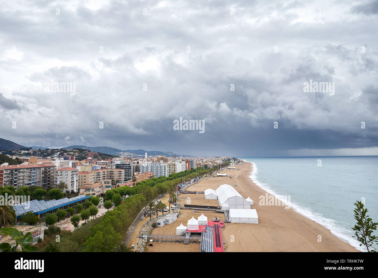 Calella beach, Spain, view from lighthouse, dark clouds, rainy, europe, party. Stock Photo