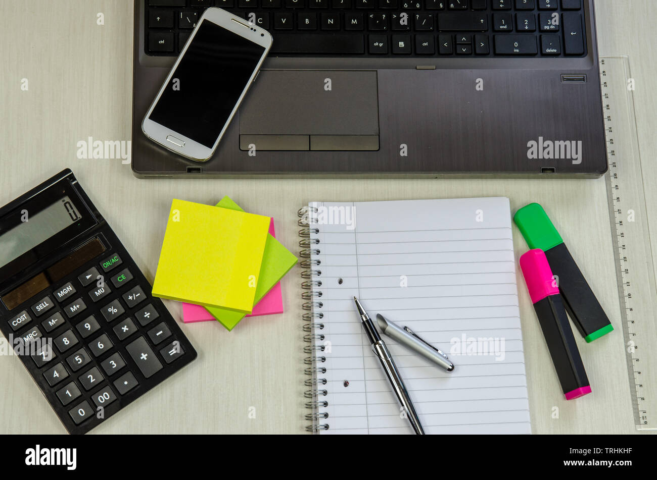 office table with laptop, pen, notepad,cup of coffee, smartphone and ...