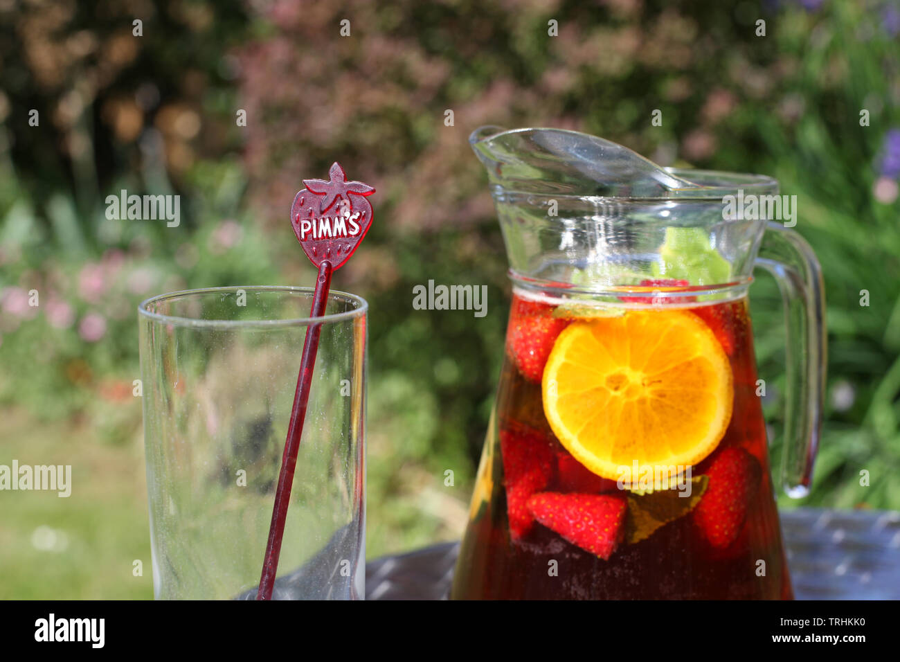 Jug of Pimms and Lemonade outside in sunshine with empty glass Stock