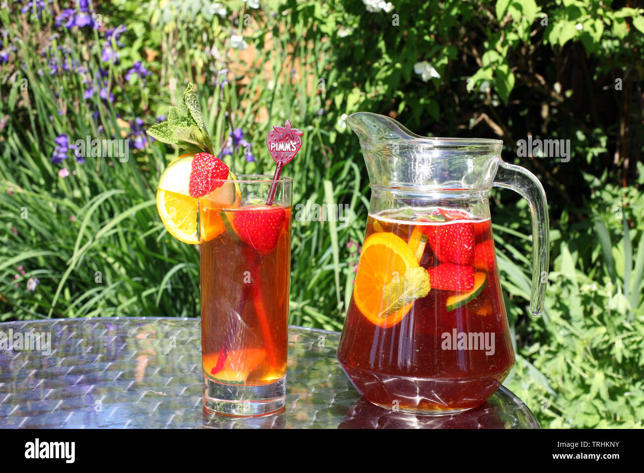 Jug of Pimms and Lemonade outside in sunshine with full glass Stock