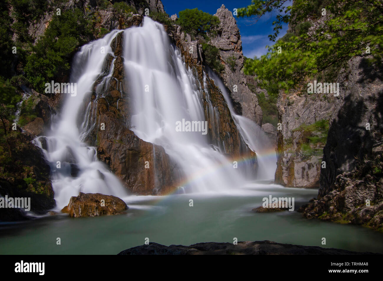 Between the mountain , the great waterfall and lake flowing in the canyon Stock Photo