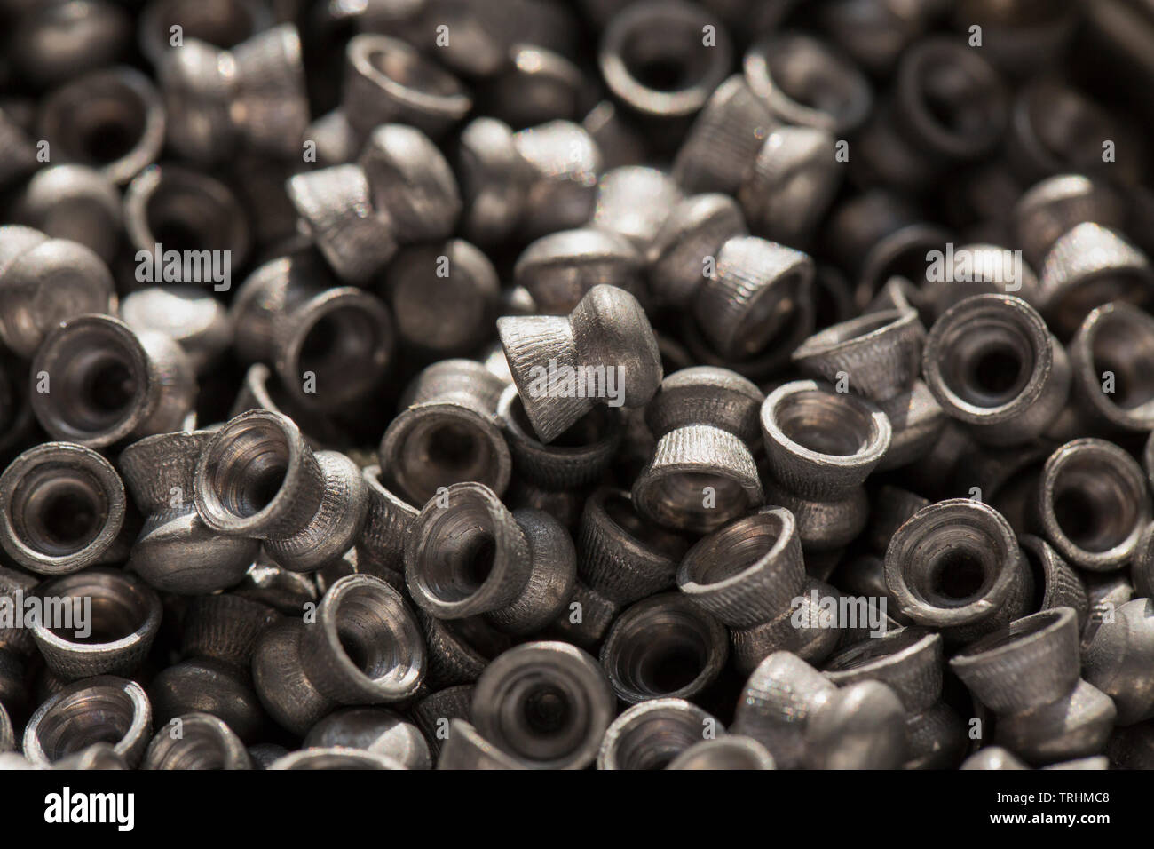 Lead .22 calibre airgun pellets on a dark stone background that can be used in either air rifles or air pistols. England UK GB Stock Photo
