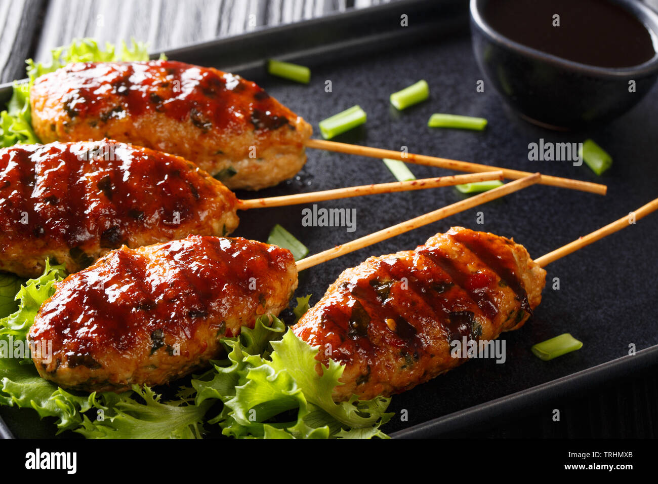 Traditional Japanese Tsukune grilled chicken meatballs closeup on a