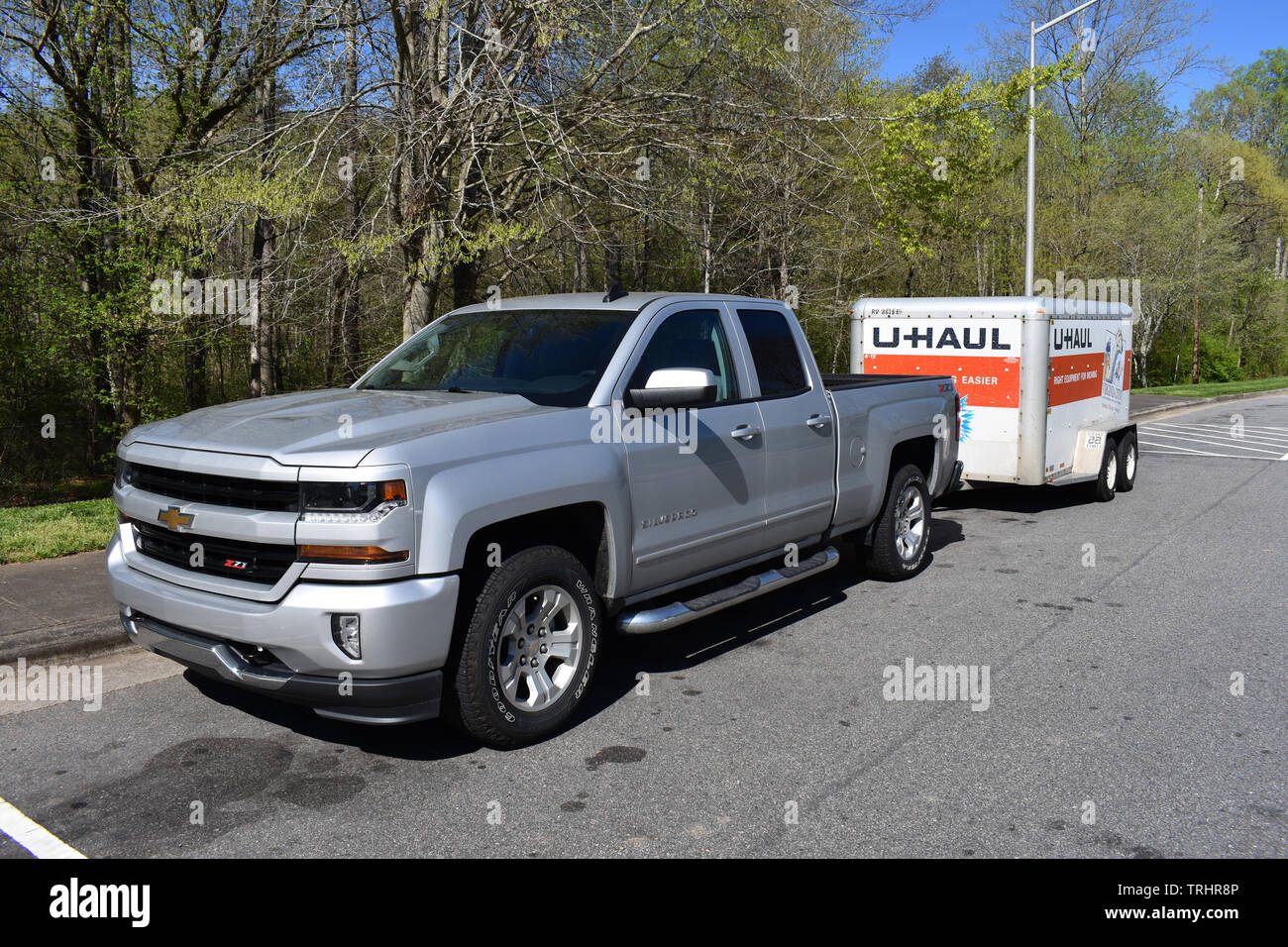 A 2018 Chevrolet Silverado Pickup Truck pulling a U-Haul trailer. Stock Photo