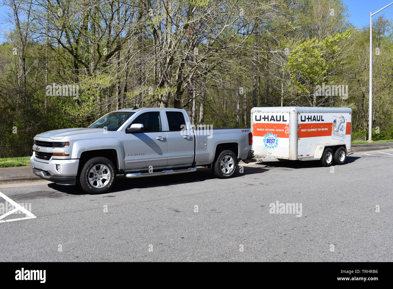 A 2018 Chevrolet Silverado Pickup Truck pulling a U-Haul trailer. Stock Photo