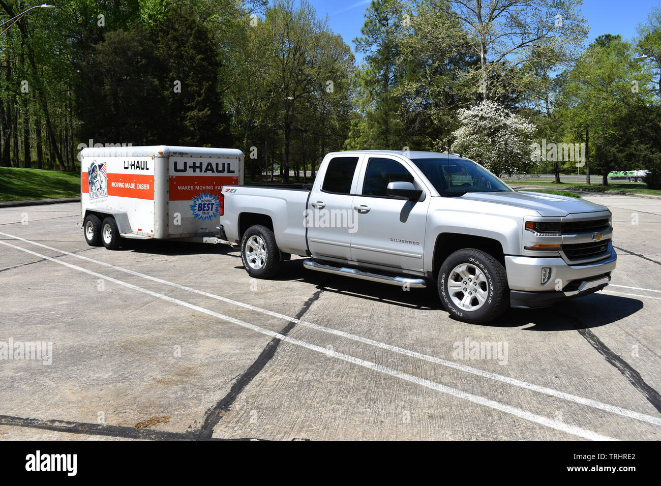 A 2018 Chevrolet Silverado Pickup Truck pulling a U-Haul trailer. Stock Photo