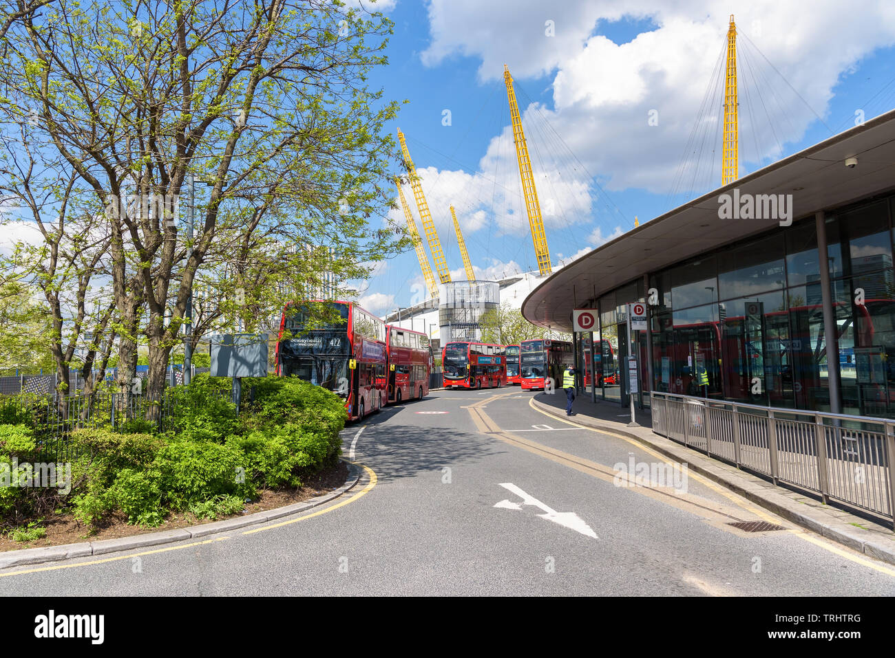 London, UK - May 1, 2018: Red double decker buses wait for passengers in front of the North Greenwich station Stock Photo