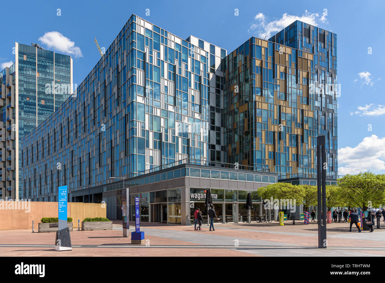 London, UK - May 1, 2018: Modern buildings with shops, bars and restaurants on Peninsula Square in front of the O2 Arena Stock Photo