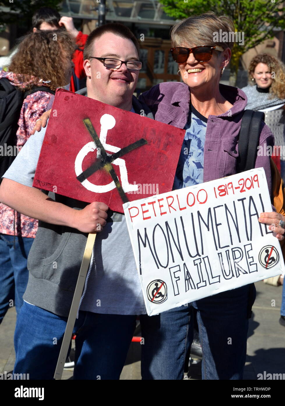 June 6, 2019. Actress and writer Ali Briggs (right) who plays Freda Burgess in TV soap Coronation Street joins disabled people and supporters protesting at the site where a memorial to commemorate the Peterloo massacre of 1819 is being built in Manchester uk. The memorial, developed by Manchester City Council, will currently be a landscaped hill made out of concentric steps. The protesters argue that it is inaccessible for many disabled people and should be amended. Stock Photo