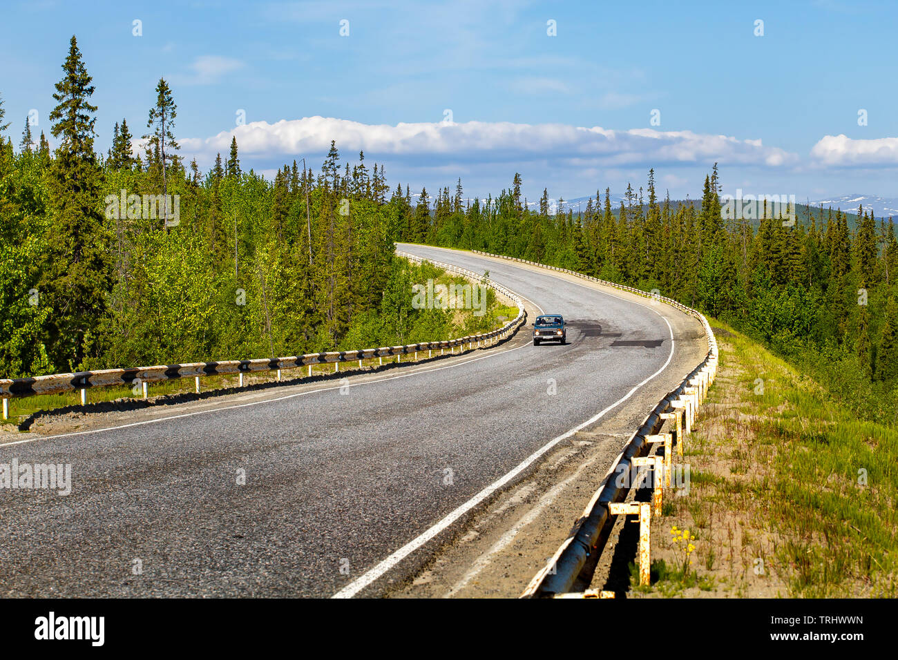 The road through the forest. North of Russia. Stock Photo