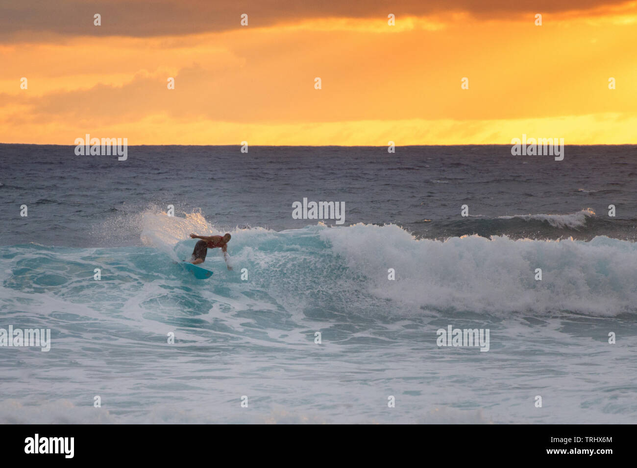 MAKAHA, HAWAII - Anonymous surfer catching a wave on Makaha Beach on January 29, 2015. The beach is reputed to be the birthplace of surfing. Stock Photo