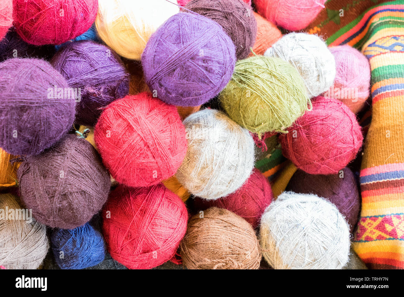 Traditional Quechuan and Peruvian textiles and balls of yarn Stock Photo