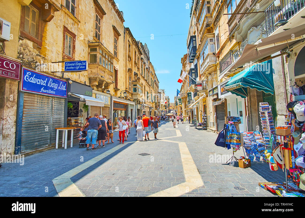 VALLETTA, MALTA - JUNE 19, 2018: One of the longest city streets - the Merchants street boasts many tourist shops, art galleries, cafes and souvenir s Stock Photo