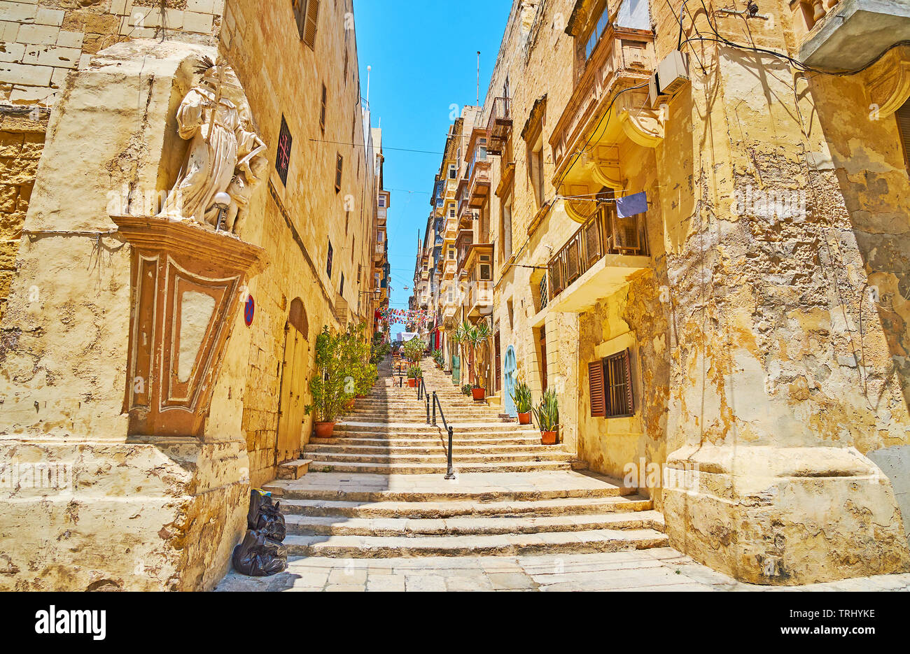 The wall statue of St Francis of Assisi decorates the corner of St Lucia street, Valletta, Malta. Stock Photo