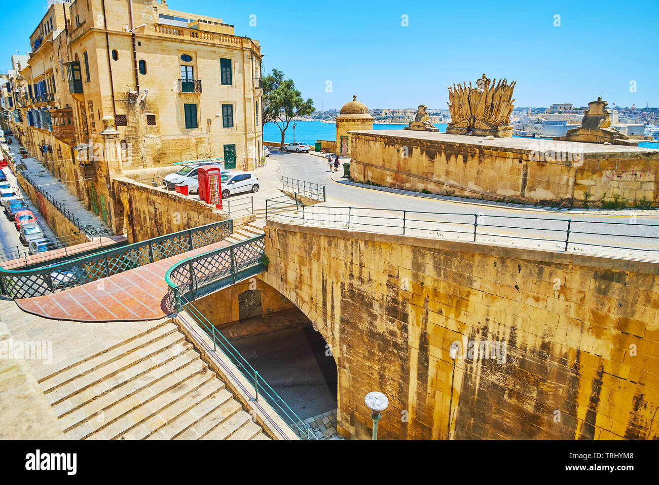 The small pedestrian bridge connects St Ursula street with upper level of Victoria gate - the part of the medieval Valletta fortiications, Malta. Stock Photo