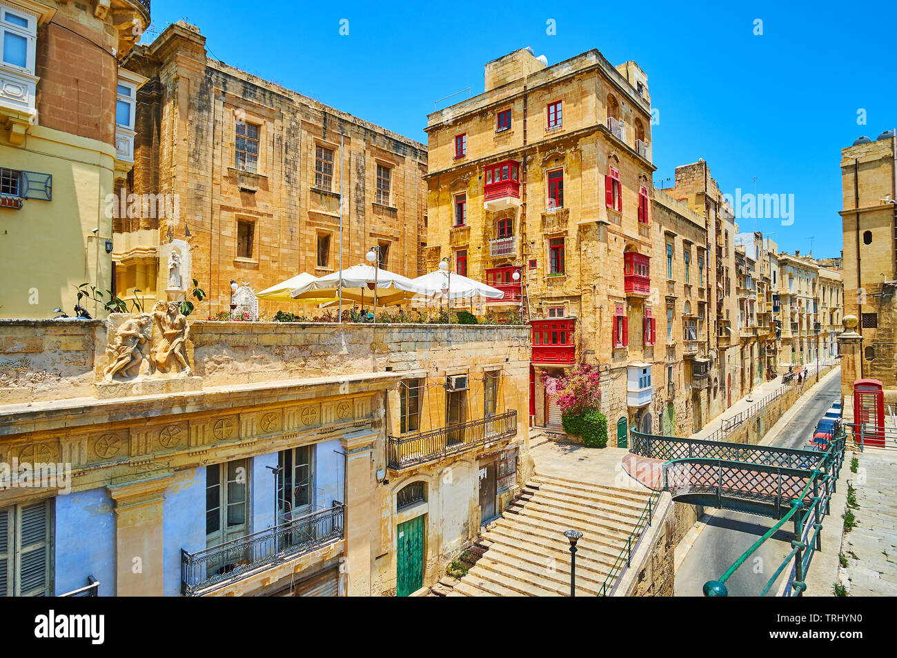 Enjoy the typical architecture of medieval Valletta with a view on living buildings in Lvant street and small pedestrian bridge to Victoria gate, Malt Stock Photo