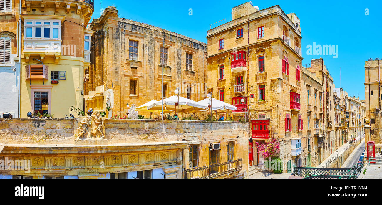 Historical quarters of Valletta consists of native limestone buildings, decorated with  colorful wooden Maltese balconies, relief patterns, sculptures Stock Photo