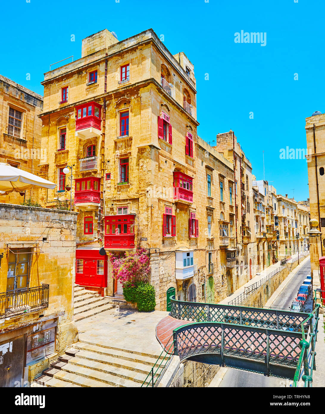 The tiny pedestrian bridge, connecting old town with medieval fortifications, stretches above Liesse street, Valletta, Malta. Stock Photo
