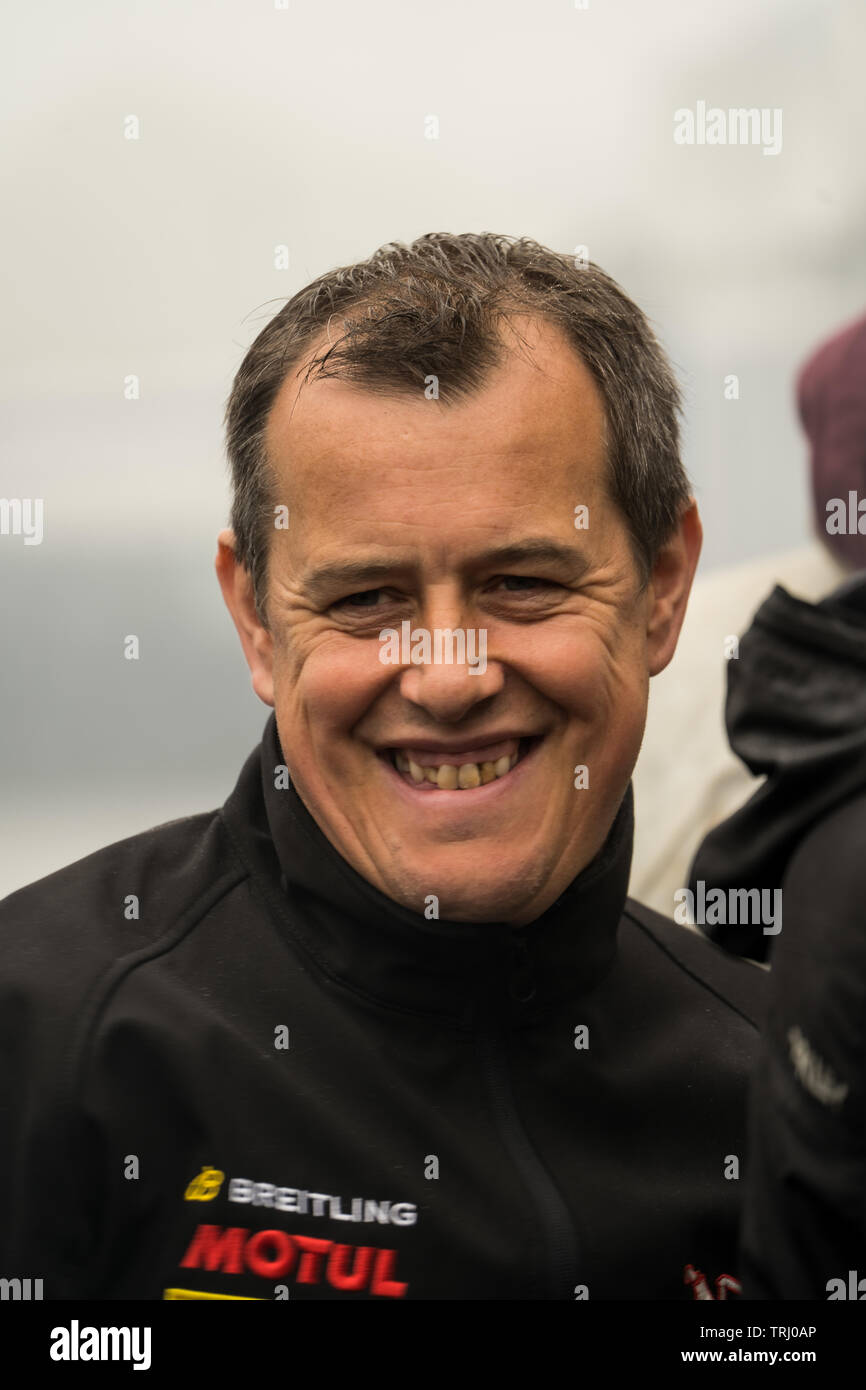 John McGuinness smiling, happy, TT motorcycle racer, informal portrait in the paddock of the Isle of Man TT, 2019 Stock Photo