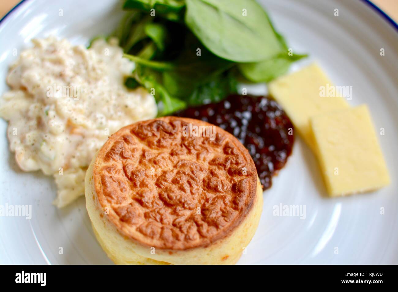 Lunch cheese souffle with relish, sliced cheddar cheese and salad Stock Photo