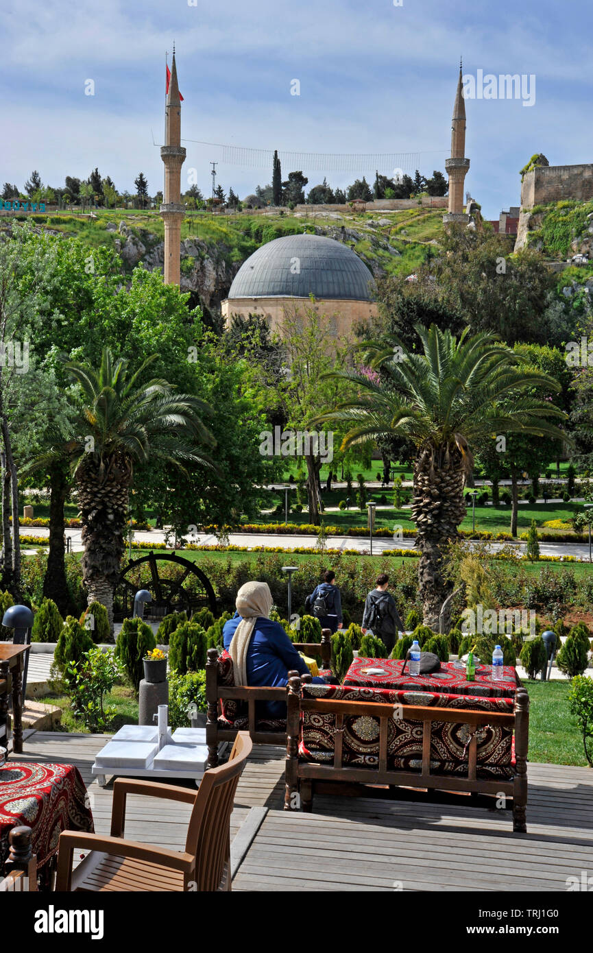 People at an outdoor cafe overlooking a mosque in Sanliurfa, Turkey Stock Photo