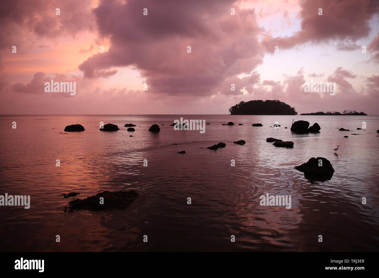 Tranquil sunset over rocky outcrops near the northern Panama town of Portobelo Stock Photo