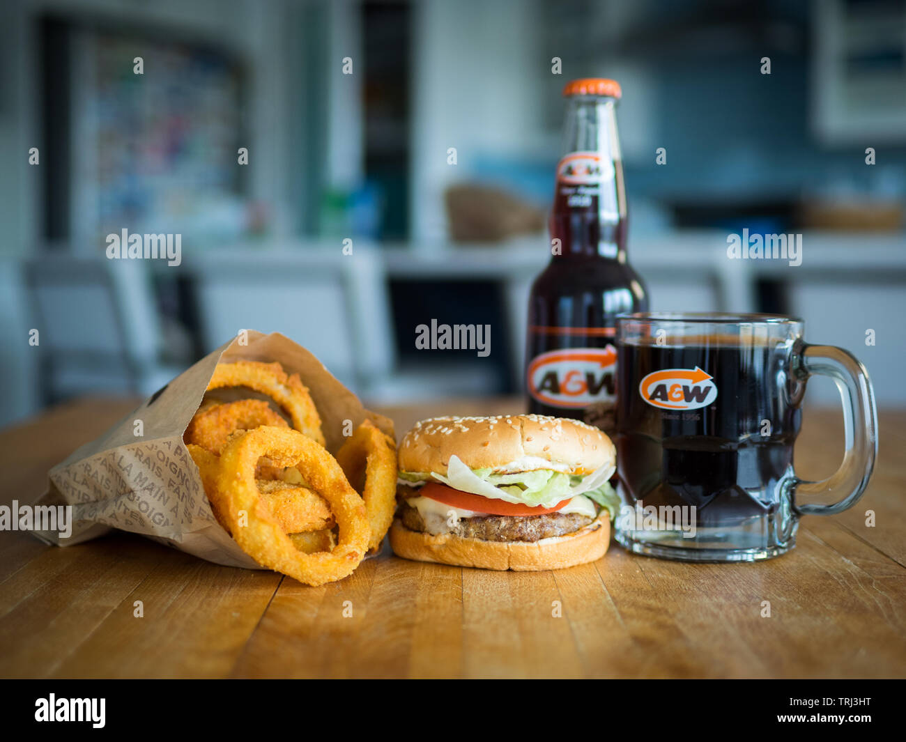 A Mozza Burger, onion rings, and mug of root beer from A&W, a Canadian fast food restaurant. Stock Photo