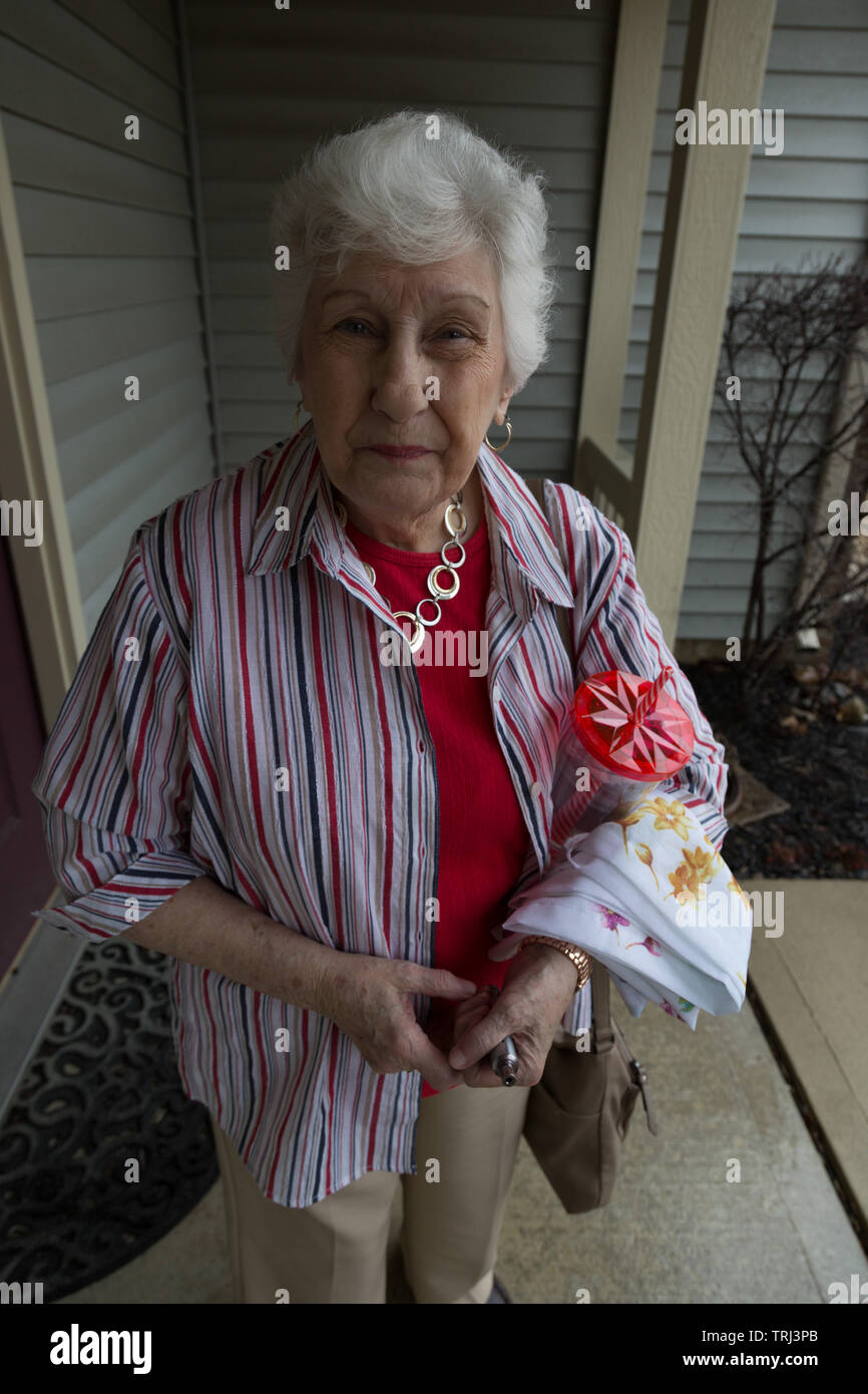 A beautiful grandma at the front door in Fort Wayne, Indiana, USA. Stock Photo