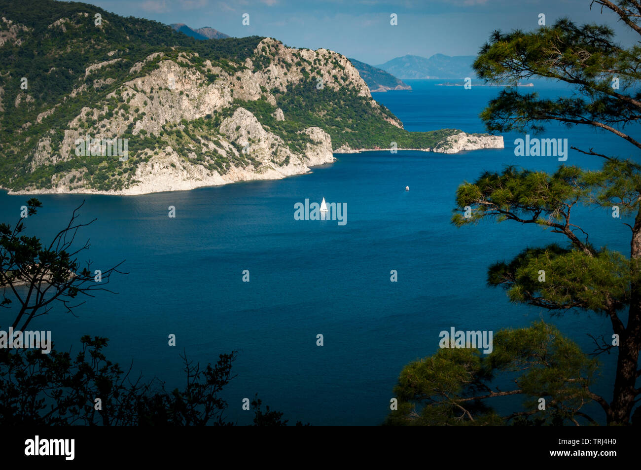 A view from the hills between Turunc and Icmeler, Turkey looking toward Marmaris amid lush pine forested hills and azure blue sea. Stock Photo