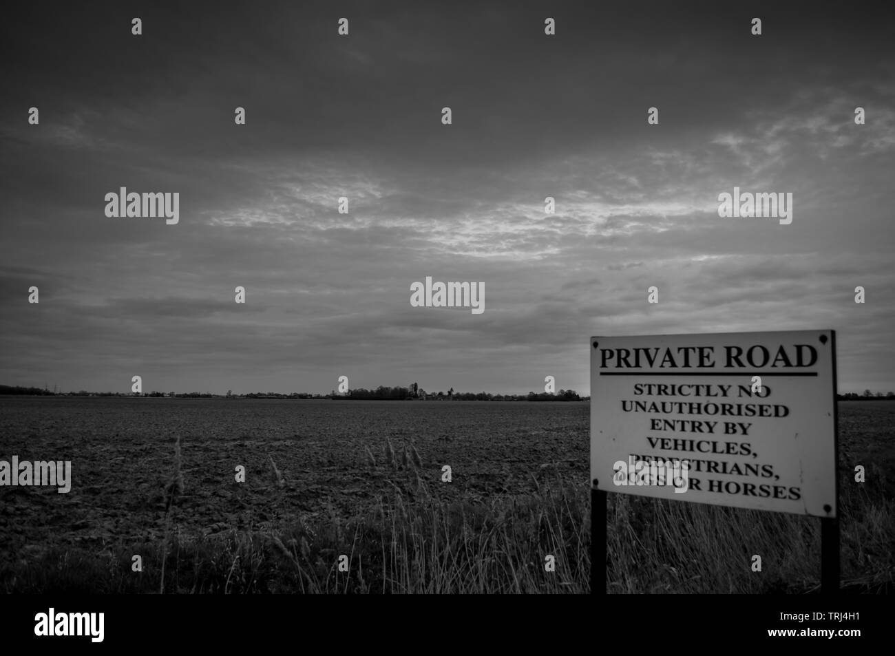 A sign forbidding entry to everything against a bleak backdrop and foreboding sky Stock Photo