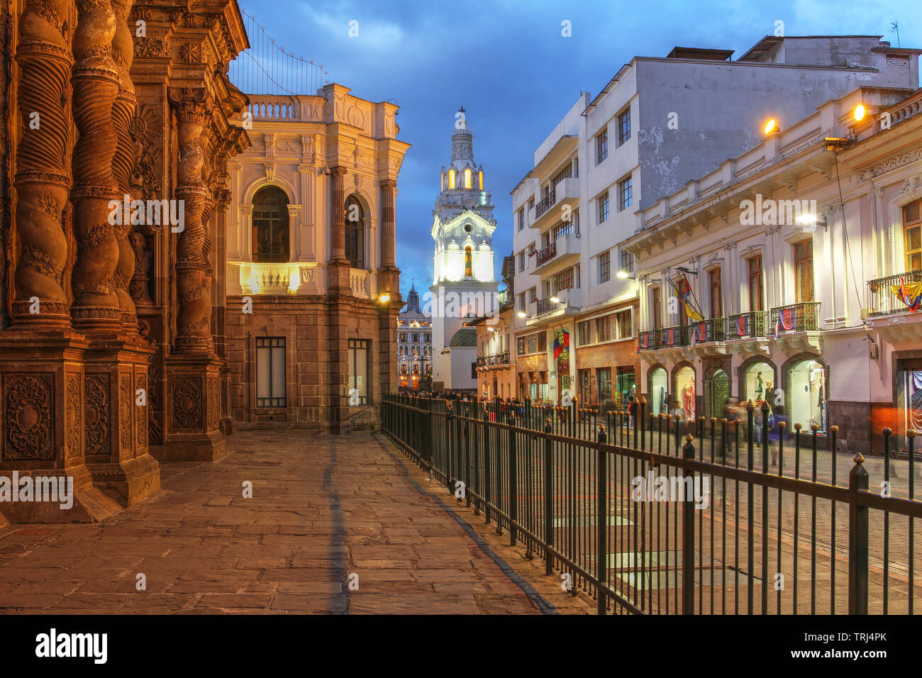 Night scene along Garcia Moreno street in Quito, Ecuador featuring Quito Cathedral and part of the Church of Jesuits. Stock Photo