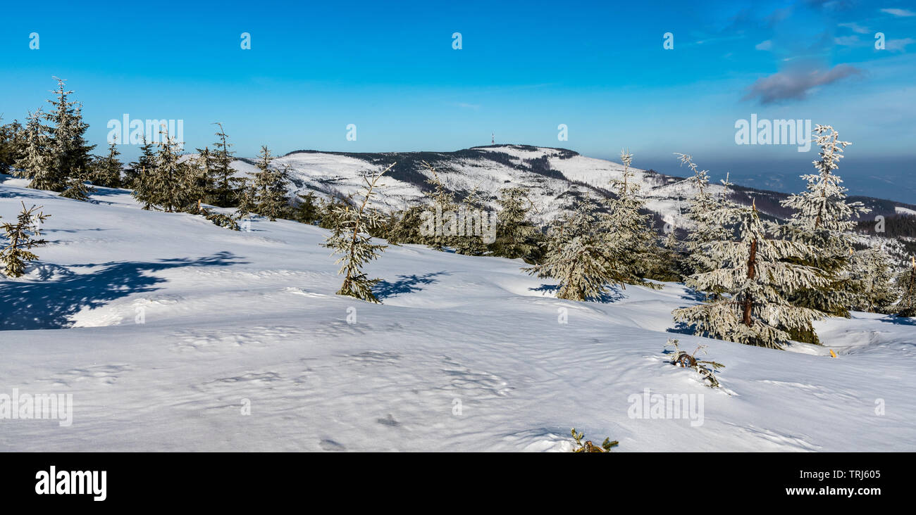 Skrzyczne and Male Skrzyczne hills in Beskid Slaski mountains in Poland during winter day with blue sky and few clouds Stock Photo