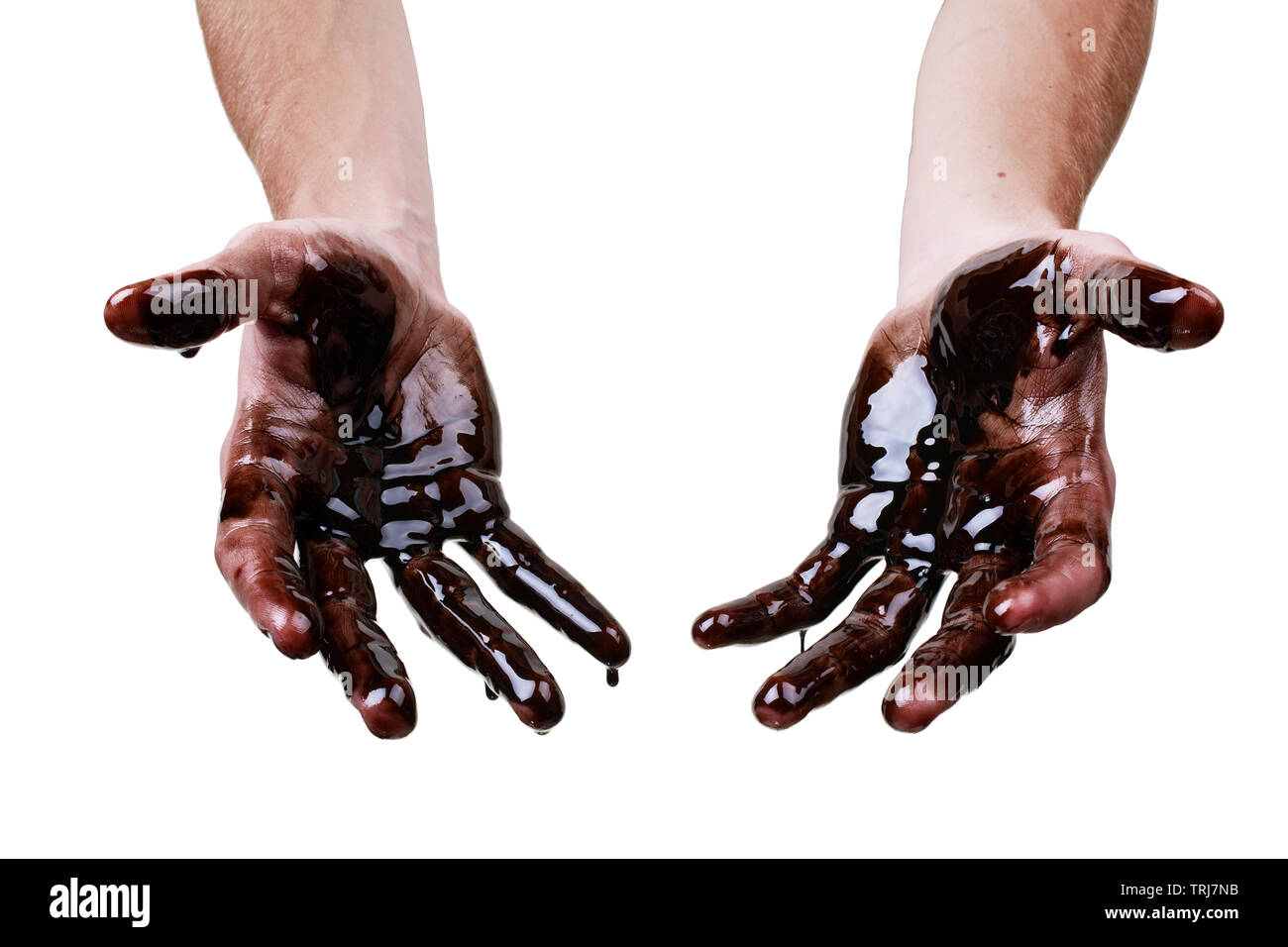 Caucasian hands cupped with black heavy fuel isolated on white background Stock Photo