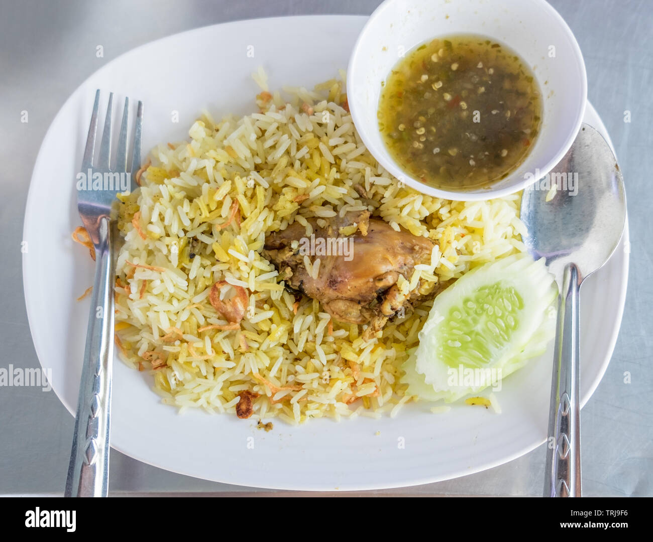 Rice with curried chicken biryani with sauce sweet and sour Stock Photo