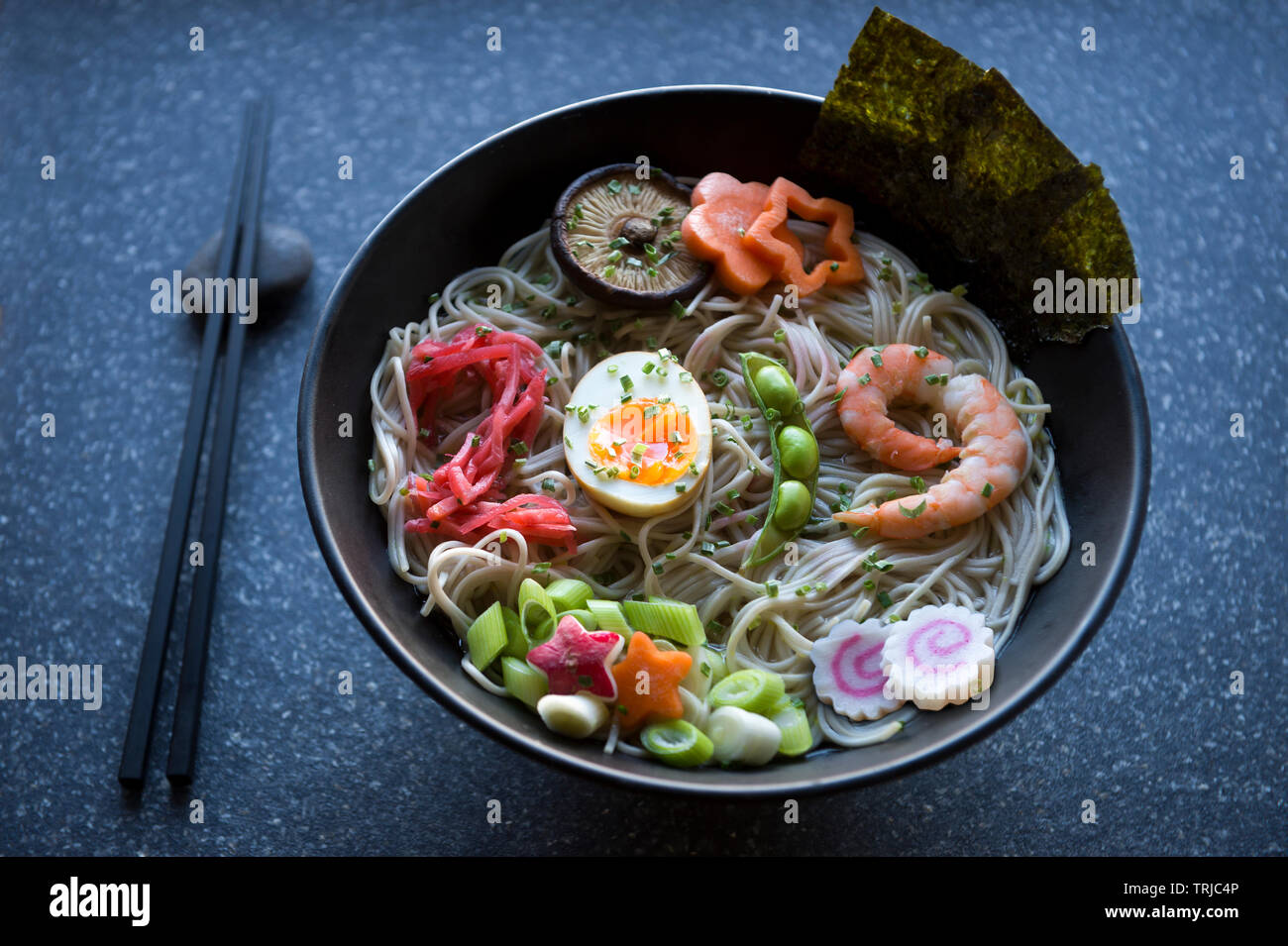 Bowl of Japanese buckwheat ramen noodle soup with colorful toppings