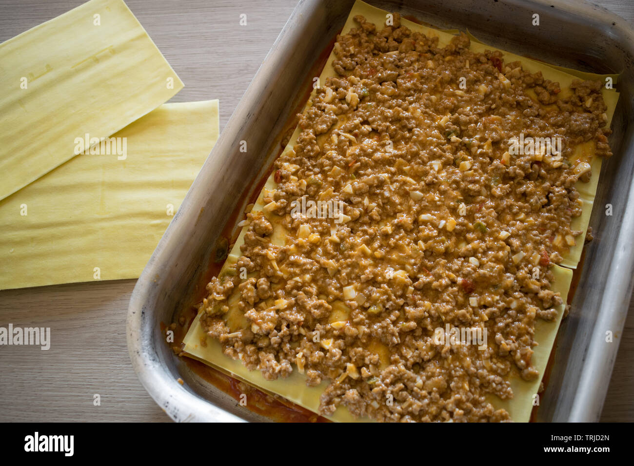 several layers and stuffing of lasagna ready to cover with bechamel. Step by Step Stock Photo