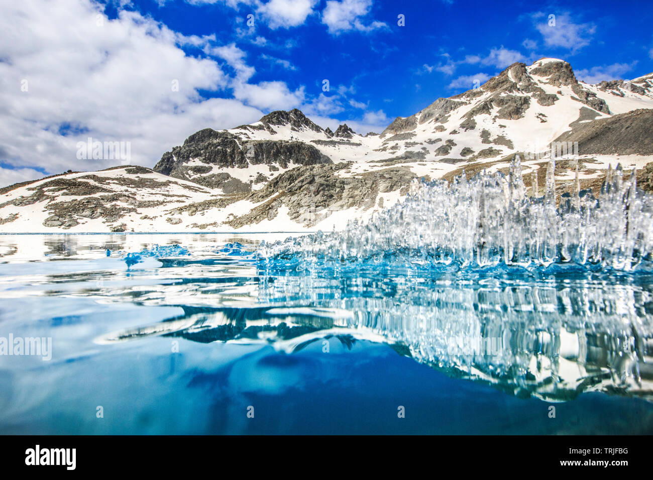 Ice crystals on water surface of Lej da la Tscheppa during spring thaw, St. Moritz, Engadin, canton of Graubunden, Switzerland Stock Photo