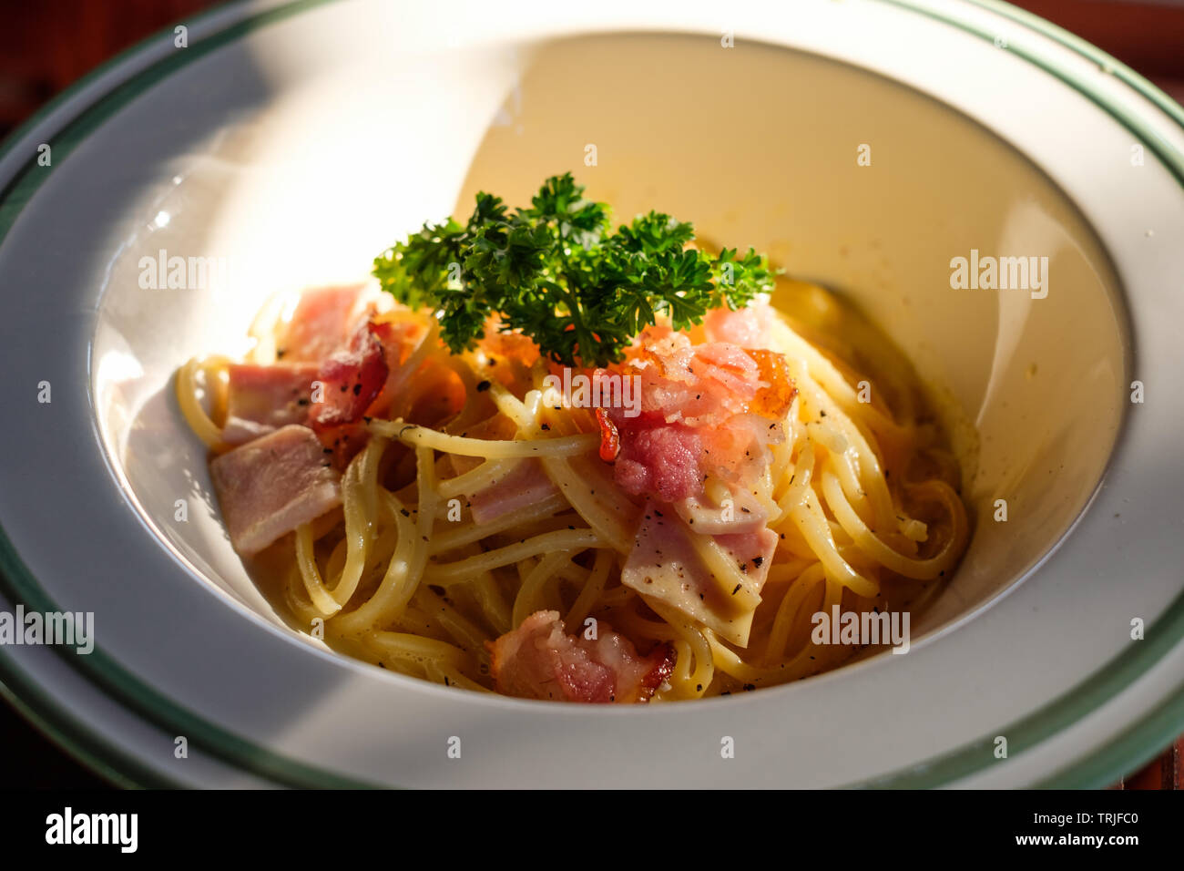 Spaghetti Carbonara With Bacon Ham And Vegetable In White Bowl At Sunset Stock Photo Alamy