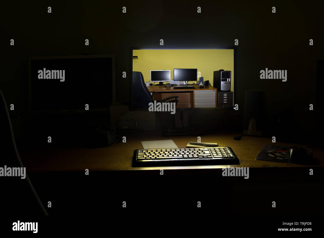 Computer screen illuminated at night Stock Photo