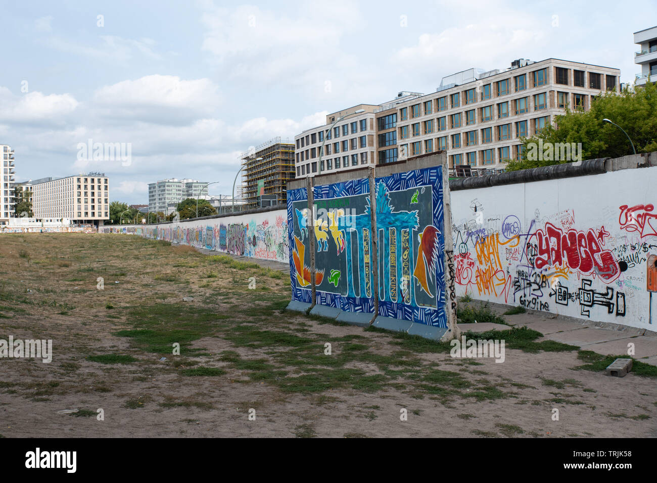 The Berlin Wall is covered with mural paintings and graffitti. Stock Photo