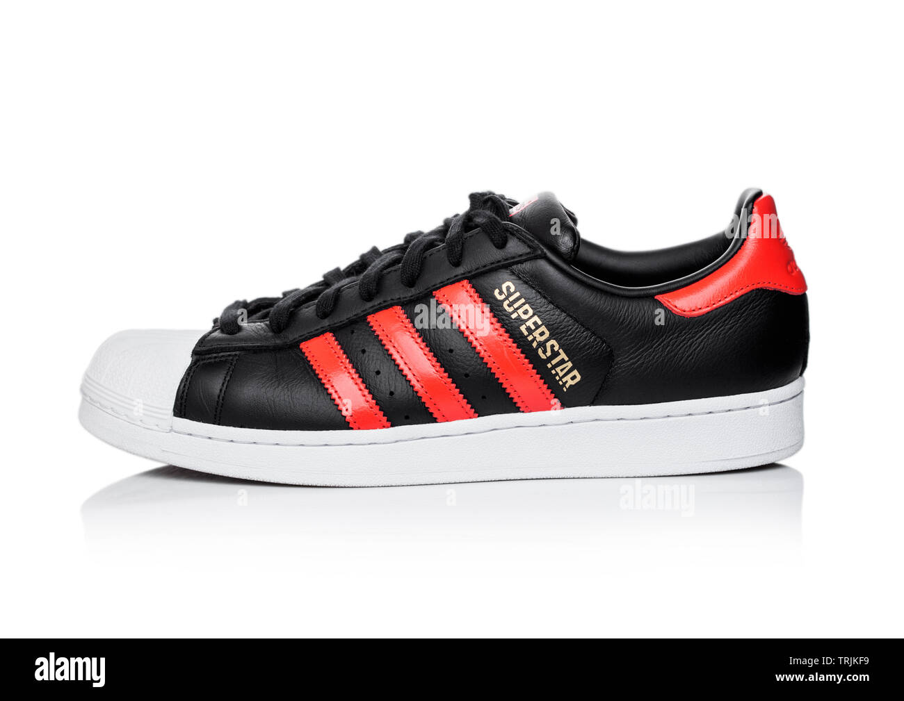 LONDON, UK - JUNE 05, 2019: Adidas Originals Superstar black shoe with red  stripes on white background Stock Photo - Alamy